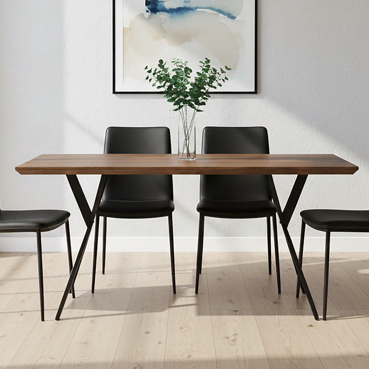 Dining area with a wooden table and black chairs, featuring a piece of abstract art on the wall.