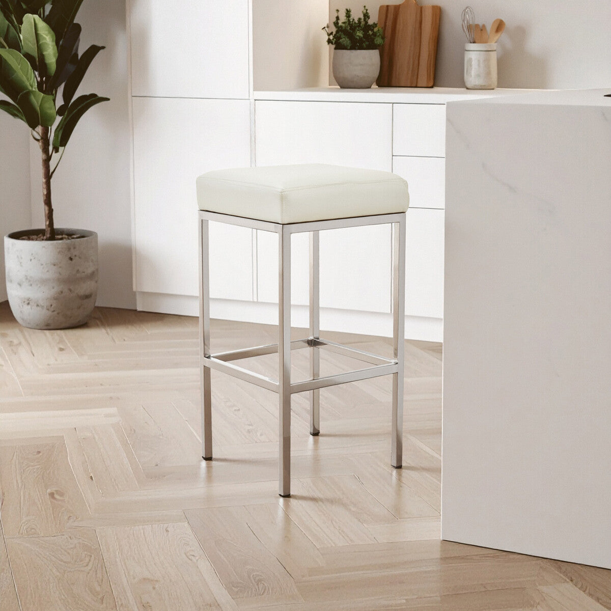 White bar stool with metal legs in a modern kitchen setting.