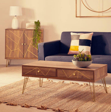 Modern living room with a blue sofa, wooden coffee table, and decorative items.