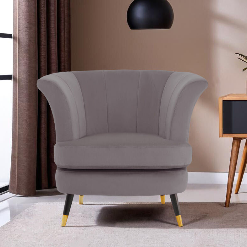 Gray armchair in a modern living room with a side table and decor items.