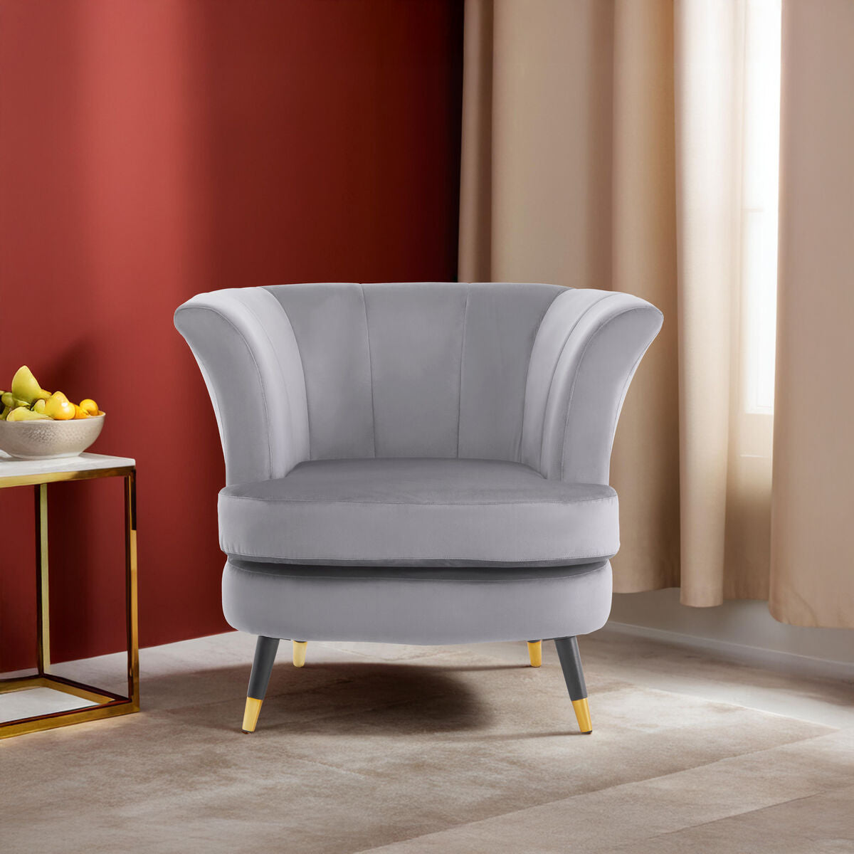 Gray armchair in a room with a red wall and beige curtains