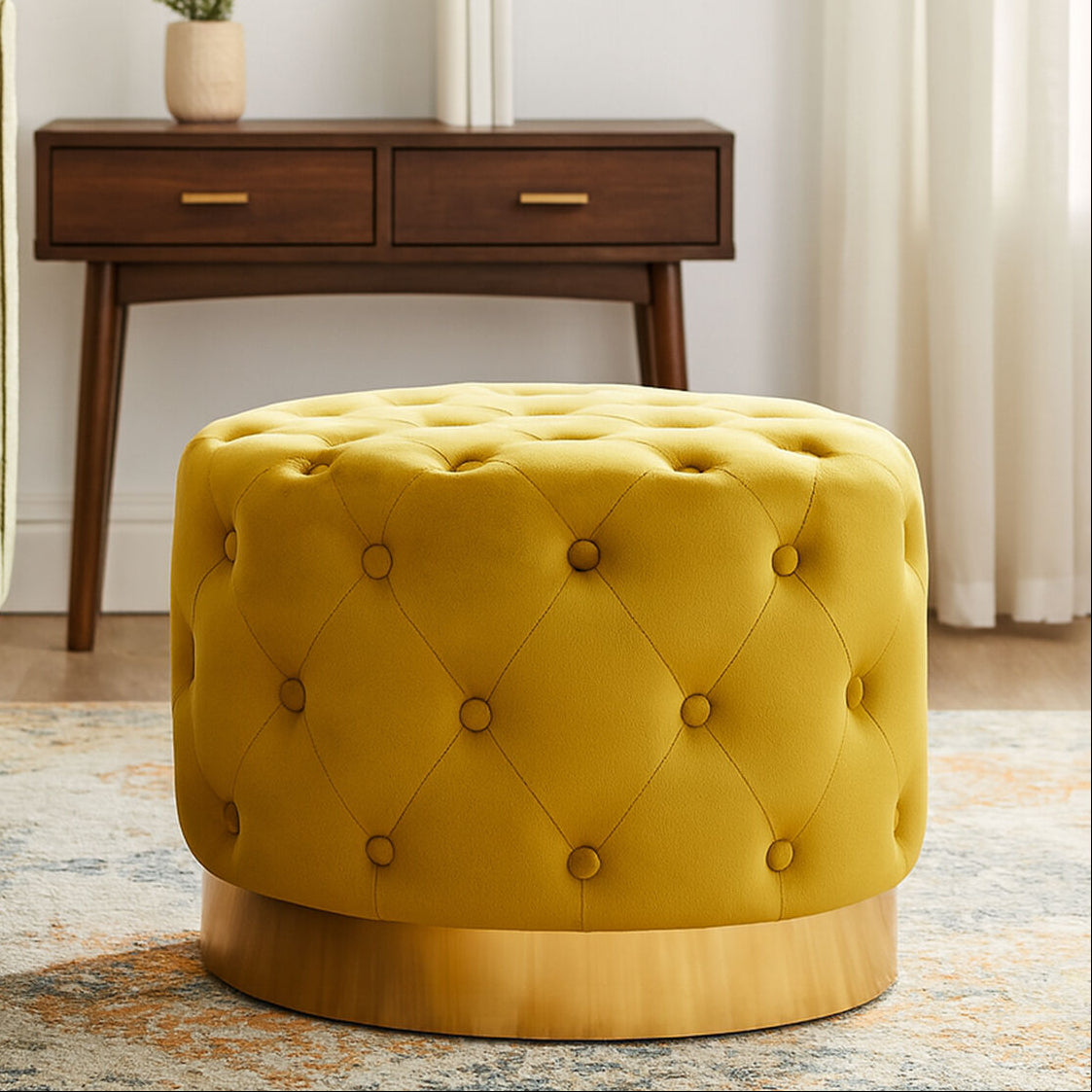 Yellow tufted ottoman in a living room setting with a wooden side table and chair.