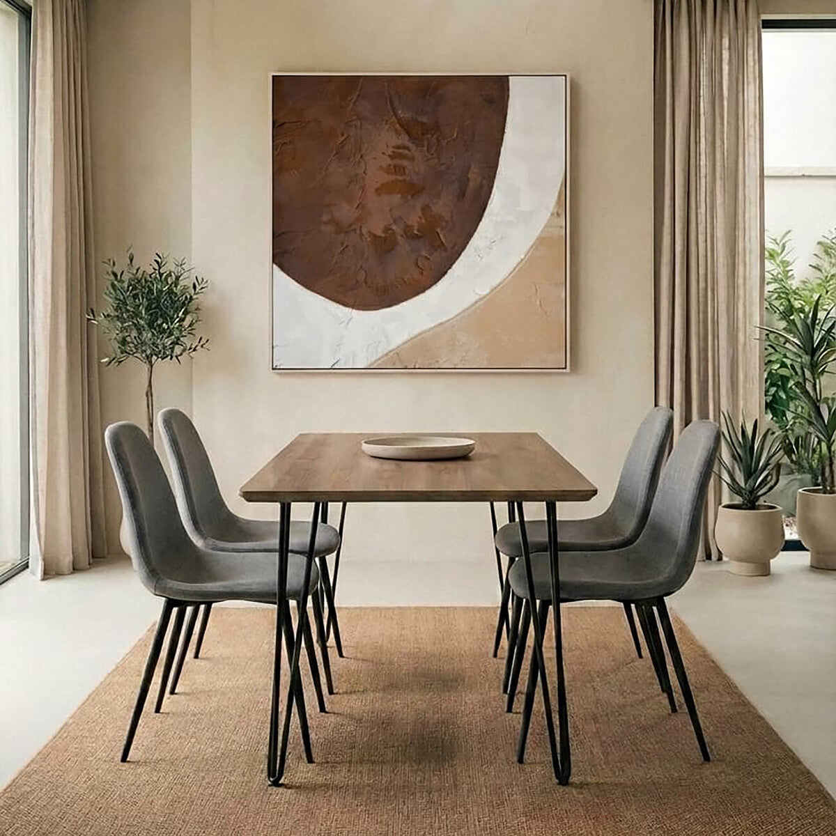 Dining room with a wooden table and gray chairs, featuring a large abstract painting on the wall.