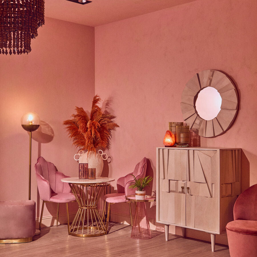 Pink interior with furniture, decor, and lighting