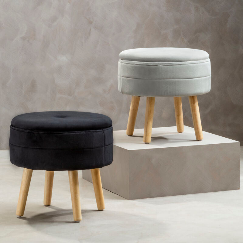 Two round ottomans, one black and one gray, with wooden legs on a neutral background.
