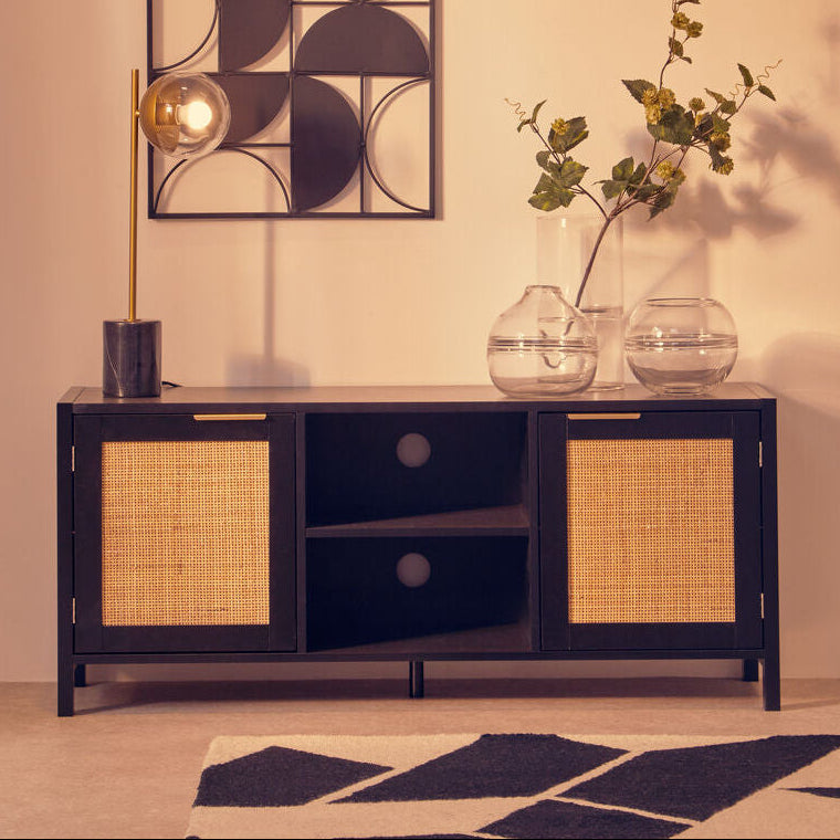 Modern living room with a black cabinet, decorative wall art, and vases.