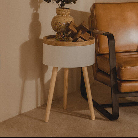 Brown leather armchair in a room with a side table and lamp.