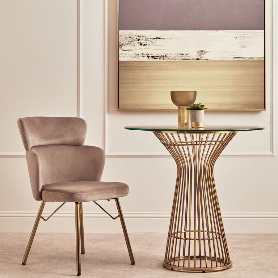 Dining chair and table in a room with abstract art on the wall