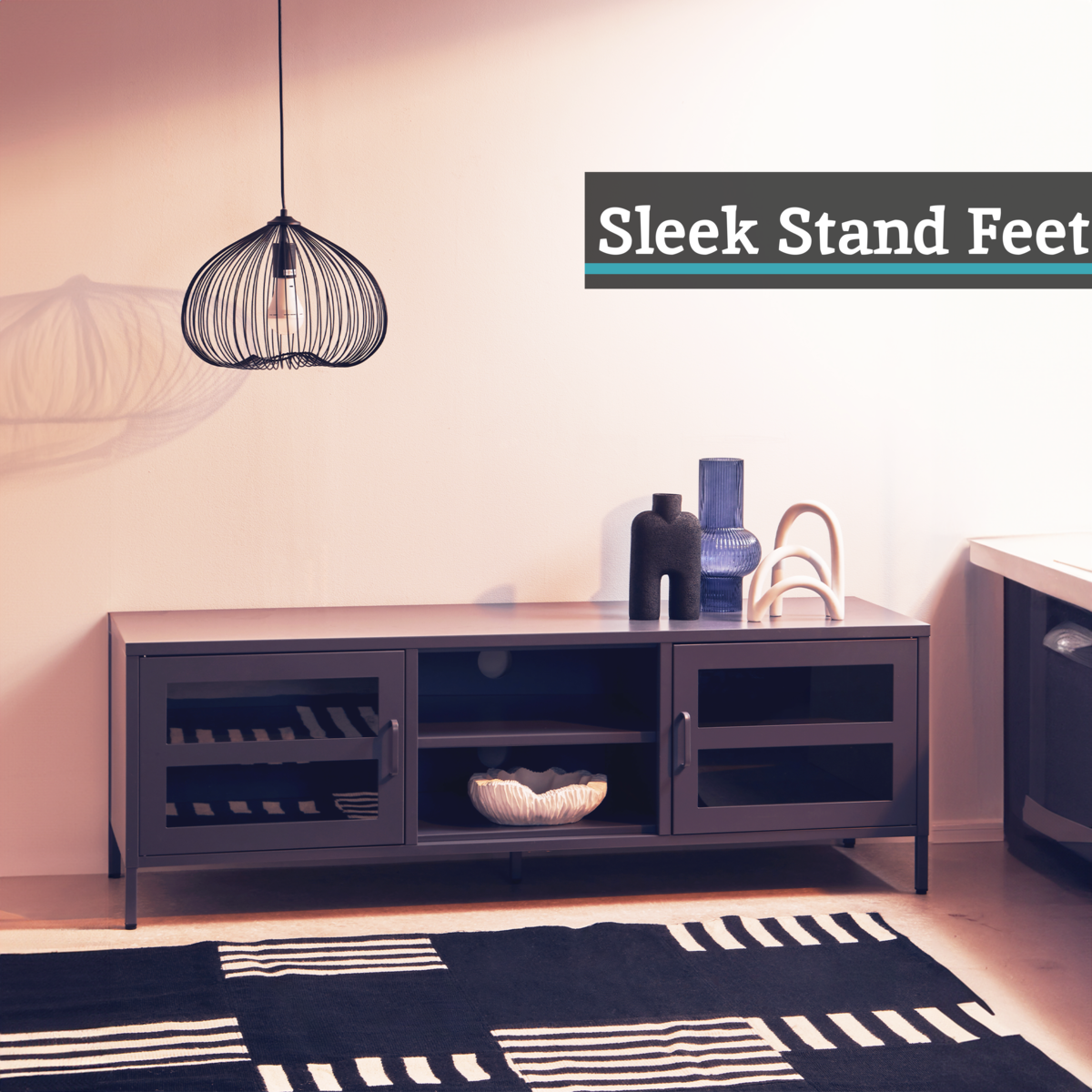 Modern living room with a dark wood TV stand, decorative items, and a stylish pendant light.