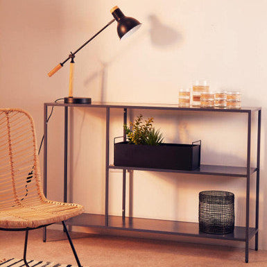 Modern interior with a console table, chair, and decorative items.