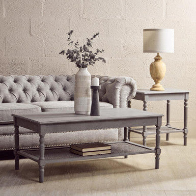 Living room with gray sofa, coffee table, and side table with lamp.