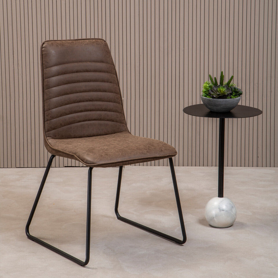 Brown upholstered chair with black metal legs in a room setting.