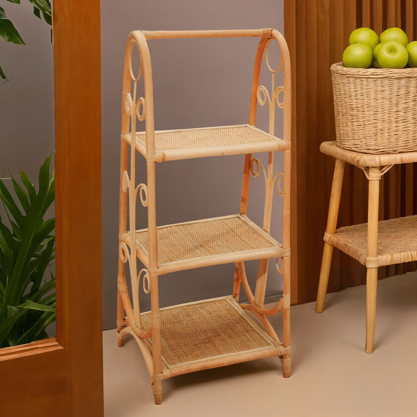 Wicker shelves with a basket of apples against a neutral background