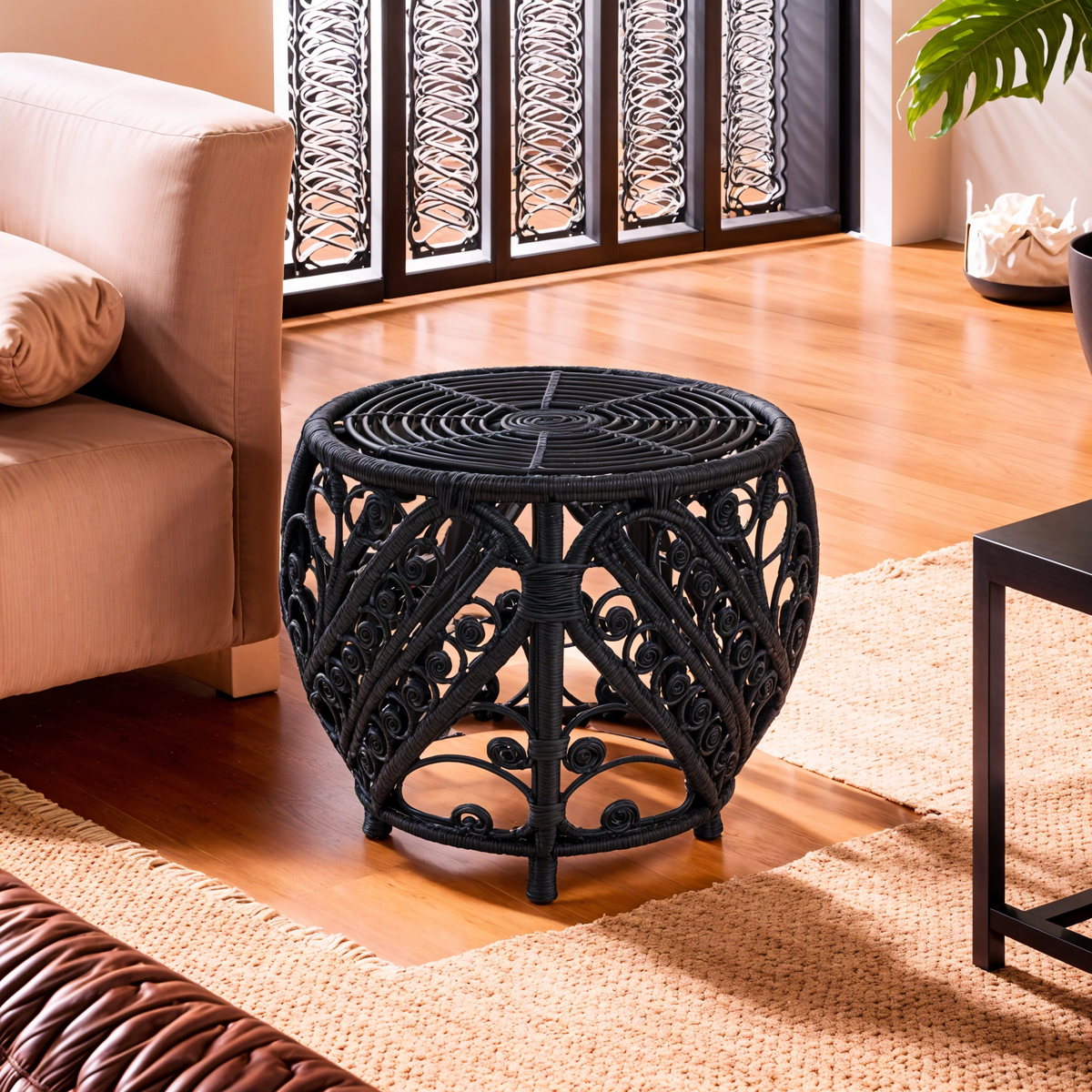 Black decorative side table in a living room setting with a couch and rug.
