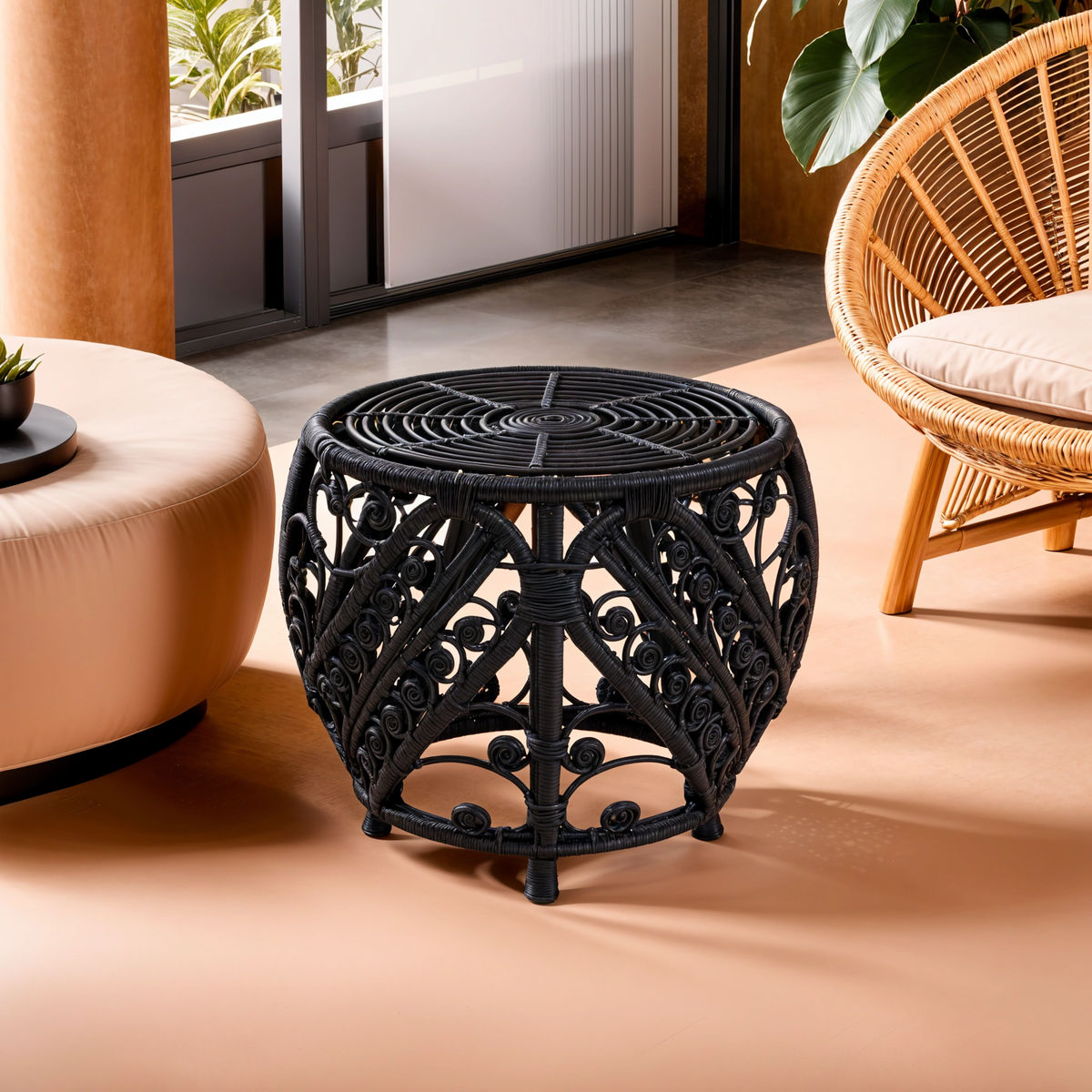 Black decorative side table in a modern living room setting with a wicker chair and ottoman.