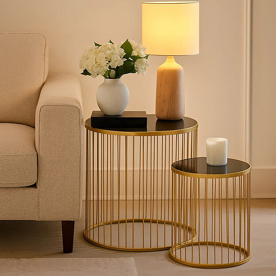 Gold side table with decorative items in a living room setting