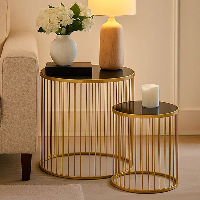 Gold side table with decorative items in a living room setting