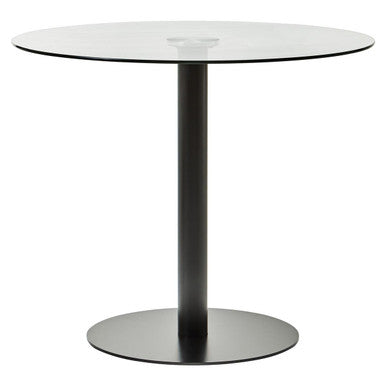 Round glass table with black metal legs on a white background