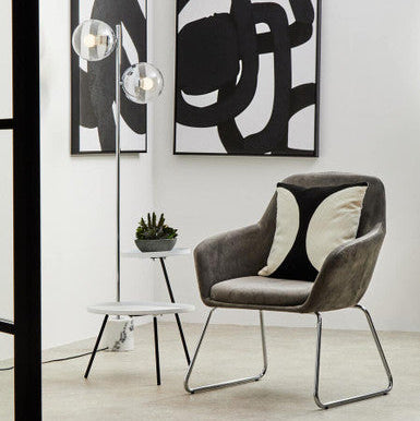 Modern chair with abstract art on a white wall