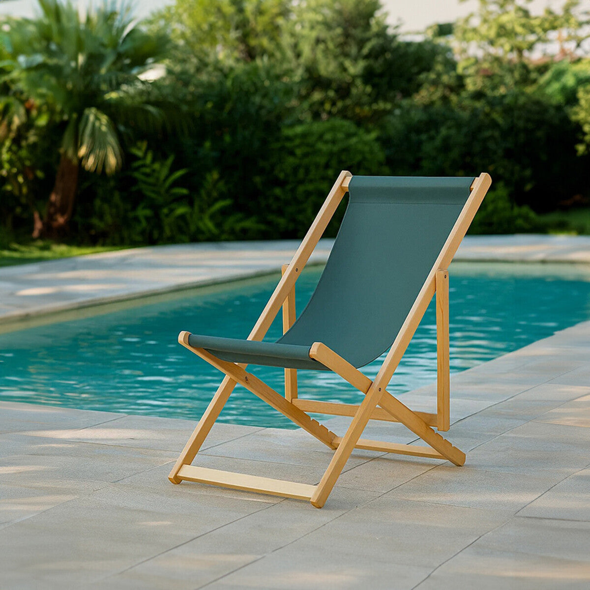 Green deck chair with wooden frame by a poolside