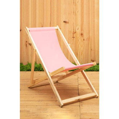Pink deck chair with wooden frame on a wooden deck