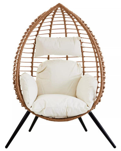 Wicker egg-shaped chair with white cushions on a white background