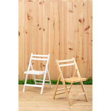 Two folding chairs, one white and one wooden, against a wooden fence.
