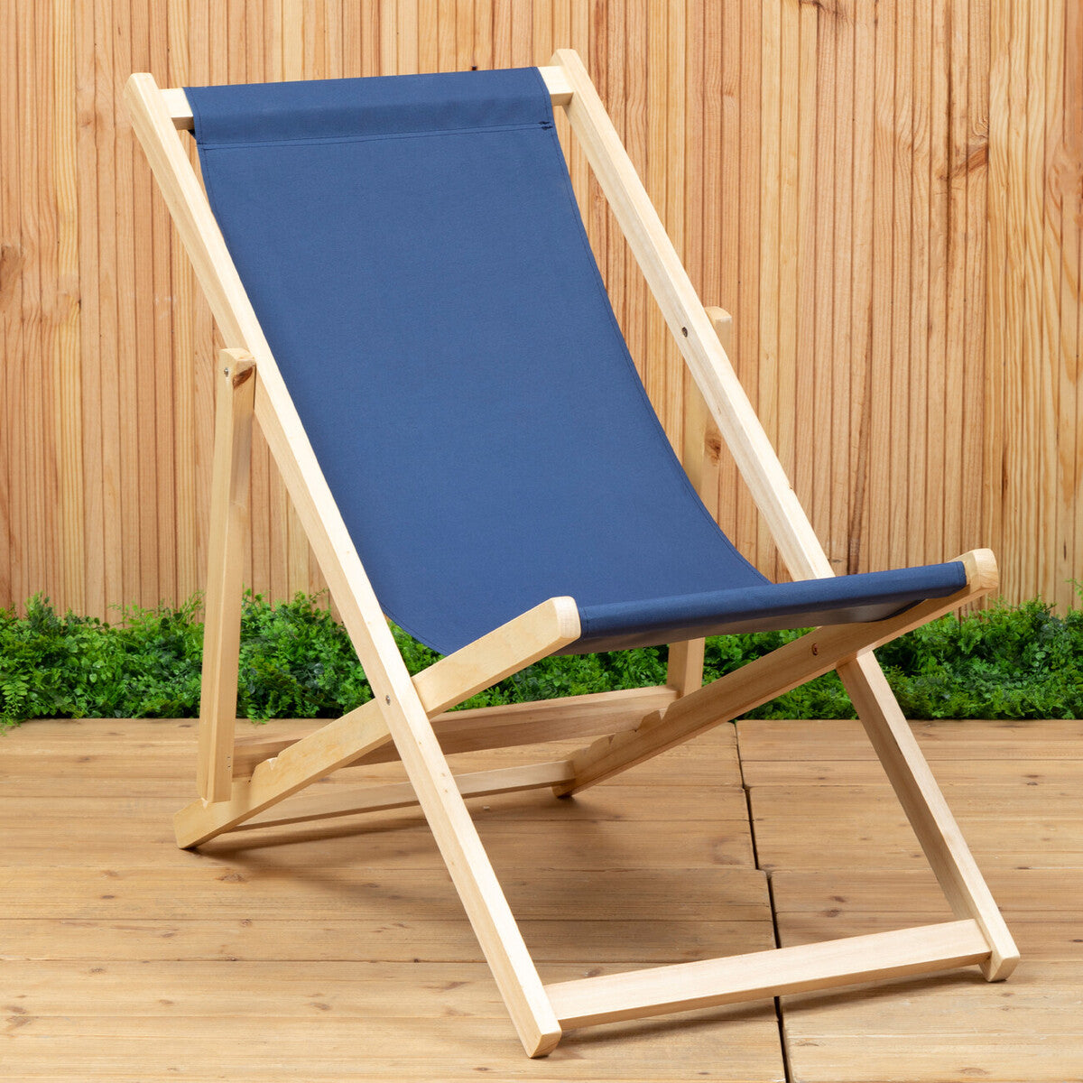 Wooden deck chair with blue fabric on a wooden deck