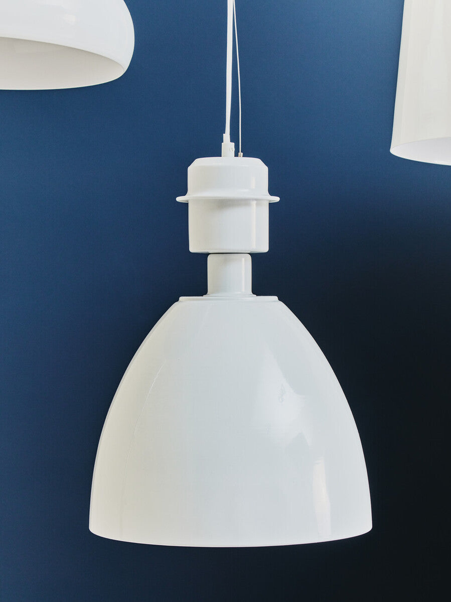 White pendant light against a blue wall