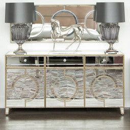 Decorative sideboard with mirror finish and two lamps on a white background