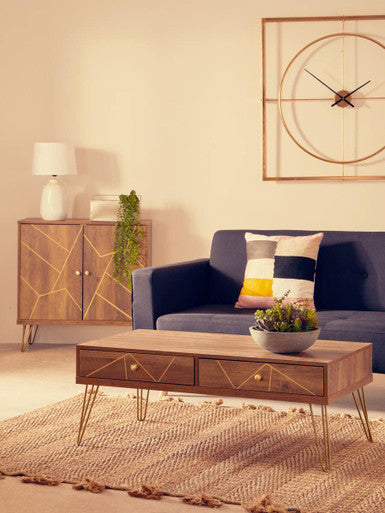 Modern living room with a blue sofa, wooden coffee table, and decorative items.