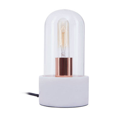 Table lamp with a white base and glass cover on a white background