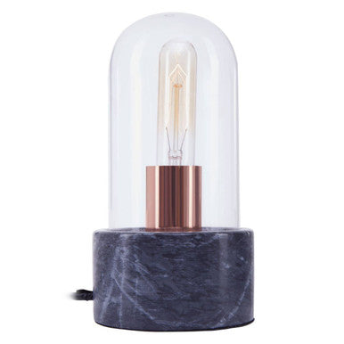 Table lamp with marble base and clear glass cover on a white background