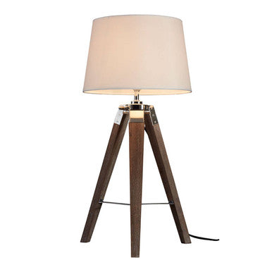 Table lamp with wooden tripod base and beige shade on a white background