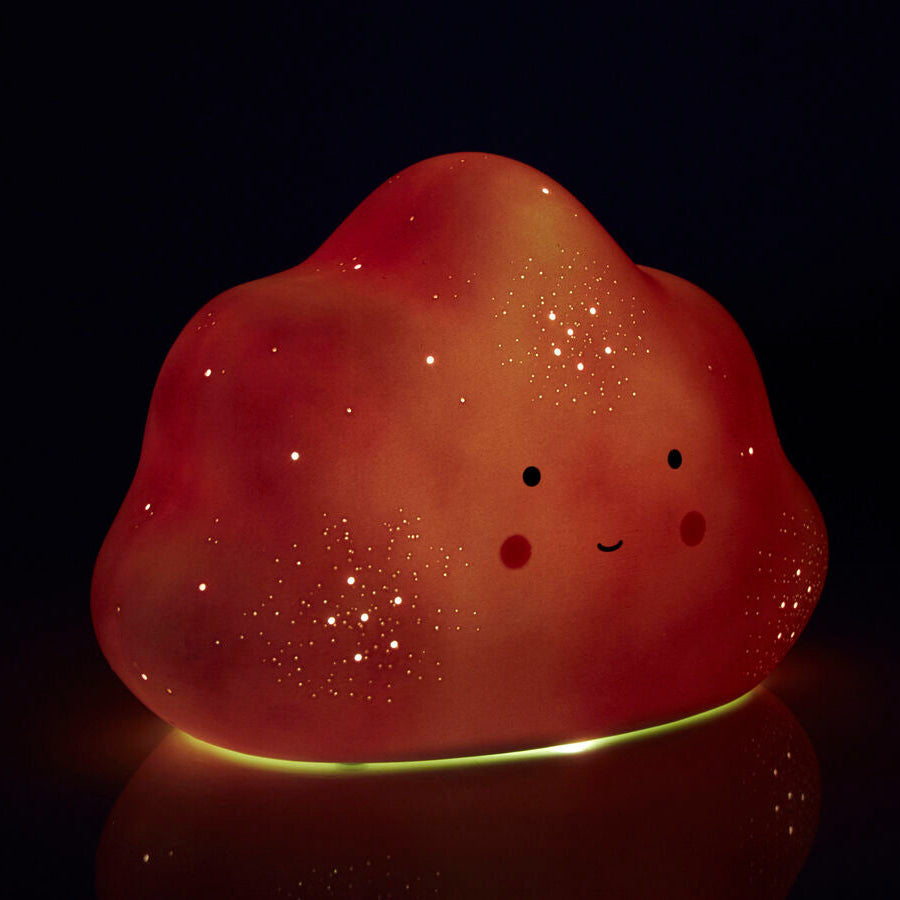 Glowing red creature with a face on a black background