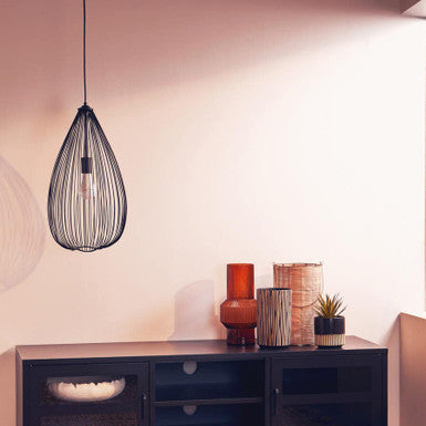 Modern living room with a black entertainment console, decorative vases, and a wire pendant light.