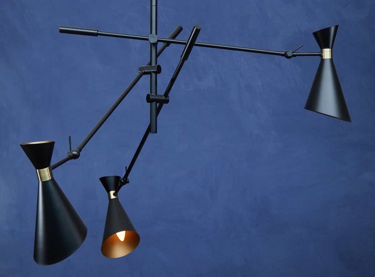 Modern black pendant light with three lampshades on a blue background