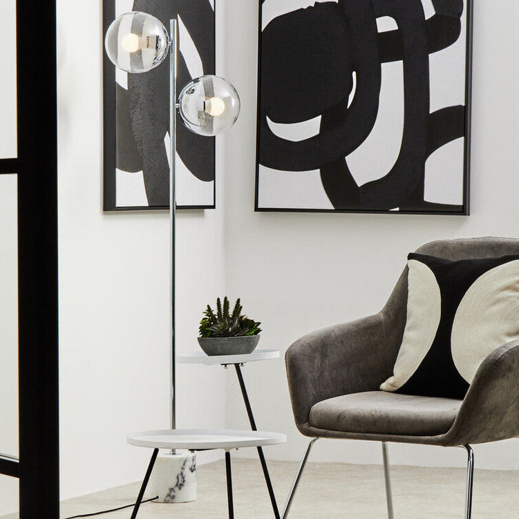 Modern chair with abstract art on a white wall