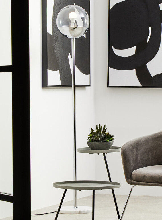 Modern chair with abstract art on a white wall