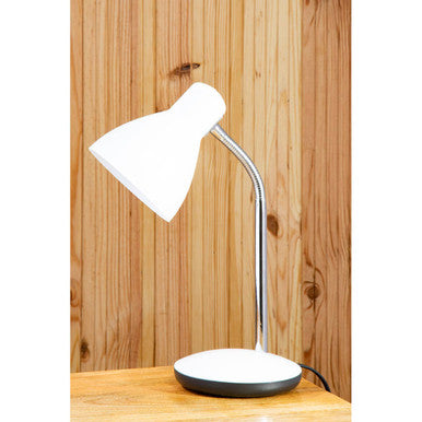 White desk lamp on a wooden surface with a wooden panel background