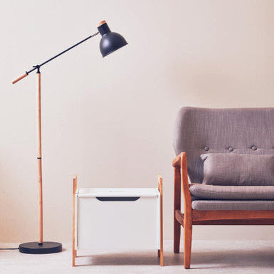 Modern floor lamp and side table in a minimalistic living room setting.