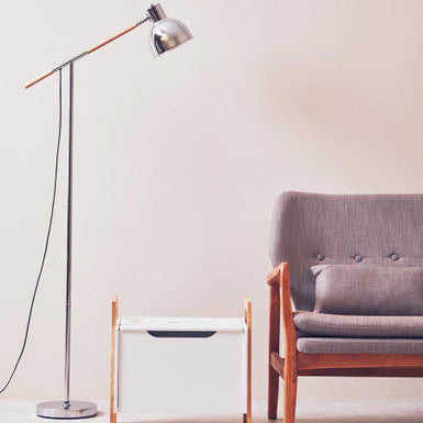 Modern living room with a floor lamp, side table, and sofa.