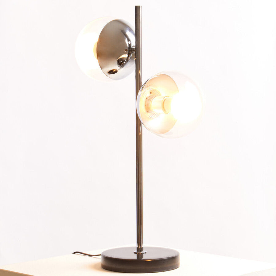 Modern table lamp with two light bulbs on a white surface