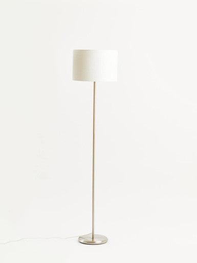 Floor lamp with a white shade on a white background