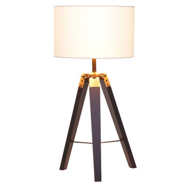 Floor lamp with wooden tripod base and white shade on a white background