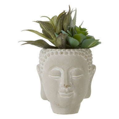 White ceramic planter shaped like a Buddha head with succulents on a white background