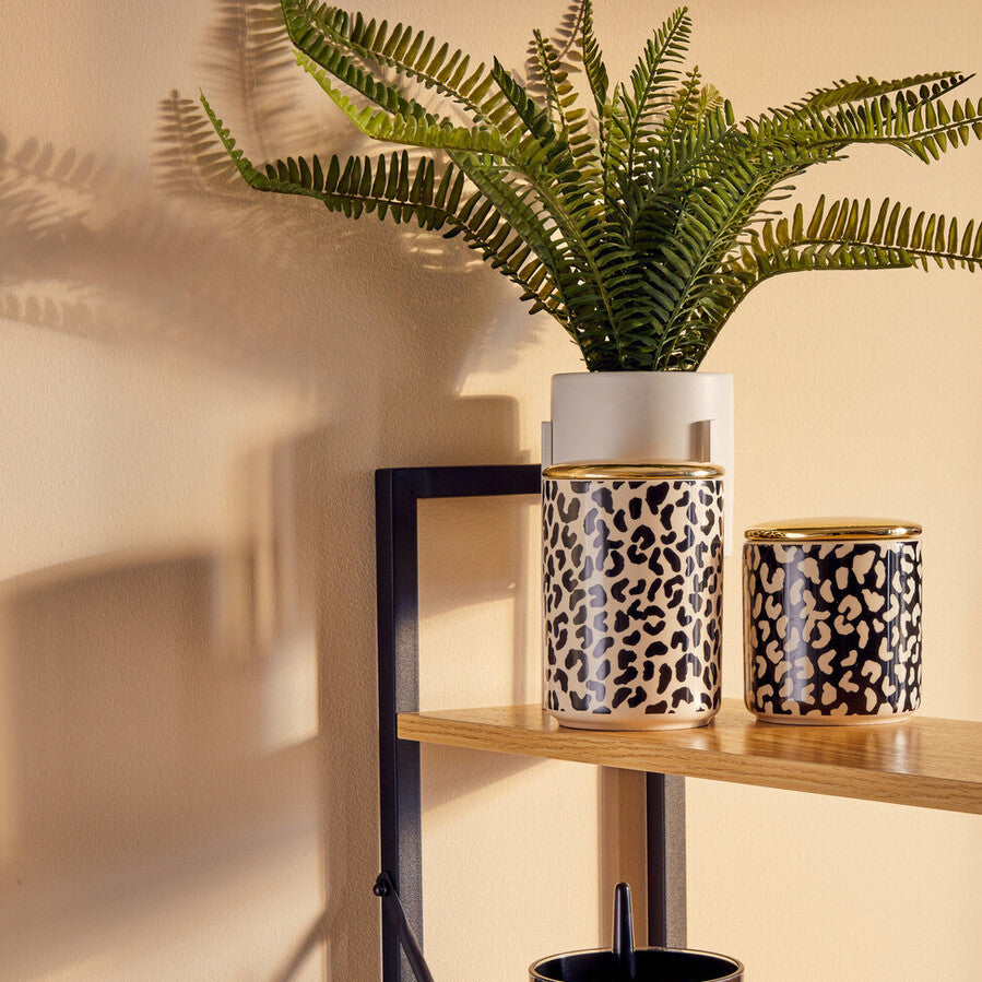 Wooden shelf with decorative plant pots against a beige wall