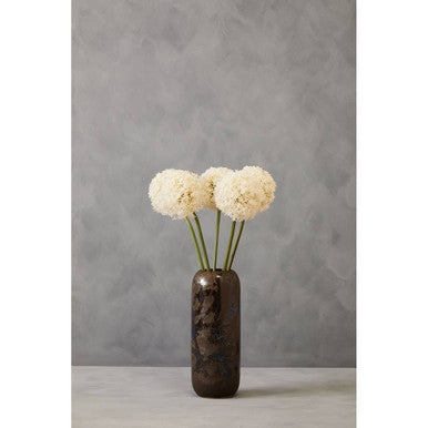 Decorative vase with white flowers against a gray background