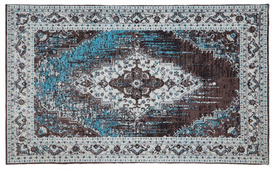 Decorative rug with intricate pattern in shades of brown, blue, and white on a plain background