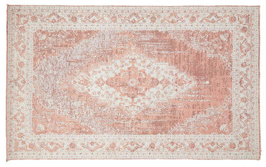 Pink and beige patterned rug on a white background